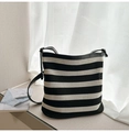 Close-up of the woven mesh texture and black leather strap of this striped tote bag - Black & White Stripes