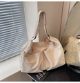 Detail view of beige nylon tote bag with dual front pockets and adjustable strap - Khaki