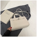 Chic beige crossbody bag with lychee texture and silver metal buckle over grey suit jacket - White Without Pendant