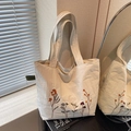 Cream canvas tote bag featuring vibrant floral embroidery and dual shoulder straps - White