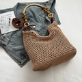 Khaki woven bucket bag featuring wooden bead handles and a brown leather strap - Khaki Large