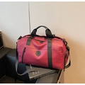 Detailed view of dark red travel bag with durable straps and front zip pocket - Red
