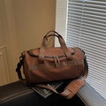 Brown cylinder gym bag with adjustable shoulder strap and durable nylon texture - Coffee