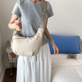 Minimalist beige nylon crescent crossbody bag with adjustable wide strap on model - Off-white
