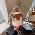 Quilted beige bucket bag with brown leather trim and scarf-wrapped top handle - Brown
