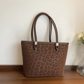 Brown leopard print tote bag in faux suede with double straps on a wooden table - Brown