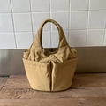 Detail of khaki nylon bucket bag showing soft texture and symmetrical front pockets - Khaki