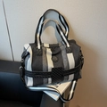 Large striped travel duffle bag in black and white with adjustable shoulder strap - Black