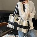 Large grey and white striped canvas travel tote bag with black trim and detachable strap - Gray