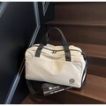 Detailed view of cream travel bag showing high-quality woven texture and black straps - Off-white