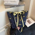 Navy denim tote bag with yellow floral embroidery and checkered bow accessory - Yellow Floral Pattern