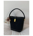 Detail of black bucket bag with matte suede texture and a cute brown bear charm - Black