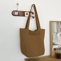 Large capacity canvas tote bag in deep khaki color with a front pocket and shoulder straps - Brown