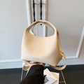 Chic beige bucket bag with lychee texture featuring a top handle and shoulder strap - White