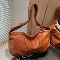 Minimalist caramel brown pleated cloud bag in soft faux leather with knotted shoulder strap - Caramel
