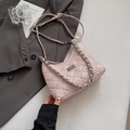 Quilted light pink crossbody bag with silver chain and glossy finish on grey suit - Small / Pink