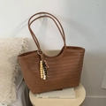 Brown woven tote bag with a long shoulder strap and colorful wooden bead tassel accessory - With Charm / Brown