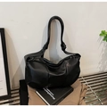 Minimalist black soft leather shoulder bag with pleated design and knotted strap detail - Black