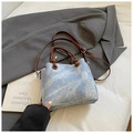 Light blue denim bucket bag with brown leather handles and adjustable shoulder strap - Blue Without Charm