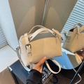 Chic beige leather trapezoid handbag with silver hardware and adjustable shoulder strap - White
