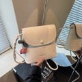 Off-white square crossbody bag with textured leather and unique knotted strap - With Charm / Off White