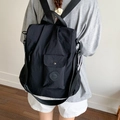 Versatile black water-resistant nylon backpack with adjustable straps and front pocket - Black