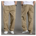 Detail view of khaki casual men pants featuring elastic waist and cotton texture - M / Earthy Yellow
