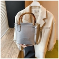 Detail of silver woven bucket bag with bamboo handle and adjustable shoulder strap - Silver