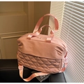 Detail of pink travel bag with diamond quilted stitching and adjustable shoulder strap - Pink