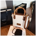 White woven tote bag with brown leather trim and vintage bamboo handles - White