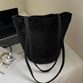 Black cylindrical bucket bag with white polka dots and long handles on a work desk - Polka Dot Style / Black