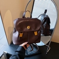 Vintage dark brown leather backpack for women with golden buckle and sleek straps - Brown