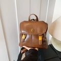 Retro brown leather backpack with gold clasp hardware in minimalist style - Brown
