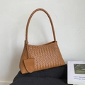 Detail of brown woven leather handbag showing intricate texture and circular top handle - Brown