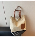 Close-up of beige canvas tote bag with brown leather pocket detail and shoulder straps - Light Khaki