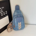 Blue denim crossbody chest bag with floral embroidery and dual zipper detail - Blue