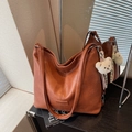 Retro brown faux leather tote bag with plush bear charm and embossed logo detail - Brown
