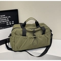 Detail of army green travel bag featuring nylon fabric and functional silver carabiner - Green