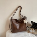 Vintage brown leather tote bag with a cute plush bear charm and long shoulder straps - Caramel color