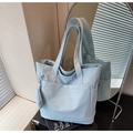 Detail of light blue tote bag showing spacious front pocket and matching round coin purse - Blue