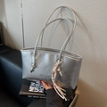Chic silver metallic tote bag with decorative knot handle and colorful tassel charms - Silver (With Pendant)