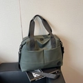 Olive green high-capacity travel and gym bag with dual front pockets and adjustable straps - Green