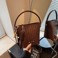Brown woven bucket bag with elegant hand strap and beaded charm in vintage style - Coffee