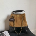 Detail view of water bucket bag with brown suede stitching and black quilted leather texture - Brown (With Pendant)