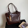 Detail of a dark brown vintage tote bag featuring decorative wooden bead tassel accents - Coffee with Pendant