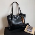 Black leather tote bag with vintage wooden bead charm and adjustable shoulder strap - Black with Pendant