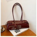 Detail of burgundy pleated leather shoulder bag with decorative gold buckle and pouch - Burgundy