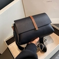 Black pebbled leather crossbody bag with wide strap and gold bar detail in a gift box - Black