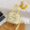 Cream canvas messenger bag with a transparent front window and bow embroidery - Yellow
