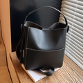 Chic black bucket bag with white contrast stitching and adjustable crossbody strap - Black